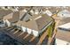 Aerial view of the rear of the property shows a screened porch and manicured shrubs at 65 Balsam Ln, Clayton, NC 27527