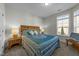 Cozy bedroom featuring a decorative wooden headboard and a window view at 65 Balsam Ln, Clayton, NC 27527