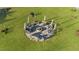 Top-down view of a community fire pit with seating and umbrellas for residents to enjoy at 65 Balsam Ln, Clayton, NC 27527