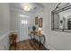 Inviting foyer with a decorative table, mirror and hardwood floors at 65 Balsam Ln, Clayton, NC 27527