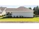 Home exterior showcasing a cozy screened porch and well-maintained lawn at 65 Balsam Ln, Clayton, NC 27527