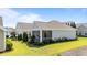 Charming single-story home featuring a screened porch and manicured landscaping at 65 Balsam Ln, Clayton, NC 27527