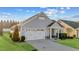 Beautiful one-story home with two-car garage, lush green grass and manicured shrubs at 65 Balsam Ln, Clayton, NC 27527