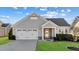 Charming single-story home boasts a two-car garage and well-maintained landscaping at 65 Balsam Ln, Clayton, NC 27527