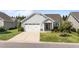 Charming single-story home featuring a two-car garage, well-manicured lawn, and lovely landscaping at 65 Balsam Ln, Clayton, NC 27527