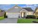 Lovely single-story home showcasing a two-car garage and neatly manicured lawn at 65 Balsam Ln, Clayton, NC 27527