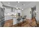 This kitchen features an island with bar seating, stainless appliances, and a tile backsplash at 65 Balsam Ln, Clayton, NC 27527