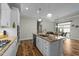 Bright kitchen island with granite countertops and stainless steel appliances with the dining room visible at 65 Balsam Ln, Clayton, NC 27527