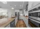 Modern kitchen featuring stainless steel appliances, granite counters, and white cabinetry at 65 Balsam Ln, Clayton, NC 27527