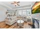 Cozy living room with a fireplace, large windows, comfortable seating and sight lines to kitchen at 65 Balsam Ln, Clayton, NC 27527