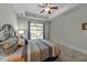 Calm bedroom featuring a decorative ceiling fan and sliding glass door at 65 Balsam Ln, Clayton, NC 27527