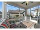 Screened patio area with seating and a view of a neighboring house at 65 Balsam Ln, Clayton, NC 27527