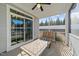 Inviting screened porch featuring a table, a comfortable bench, and a ceiling fan at 65 Balsam Ln, Clayton, NC 27527