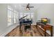 Light-filled sun room with a piano, desk and lots of windows at 65 Balsam Ln, Clayton, NC 27527