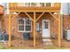 Exterior shot of the backyard featuring an exterior door, window, and brick foundation at 707 Sutter Gate Ln, Morrisville, NC 27560
