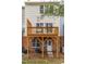 Exterior shot of the backyard featuring an exterior door, window, and brick foundation, and wood deck at 707 Sutter Gate Ln, Morrisville, NC 27560