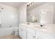Bright bathroom features a double vanity, a full mirror, and a shower over tub at 707 Sutter Gate Ln, Morrisville, NC 27560