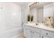 Clean bathroom with a white vanity, mirror, tub and shower combo at 707 Sutter Gate Ln, Morrisville, NC 27560