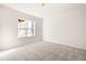 Bright, carpeted bedroom with natural light streaming through a large window at 707 Sutter Gate Ln, Morrisville, NC 27560
