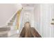 Welcoming entryway with carpeted stairs, hardwood floors, and white wainscoting leading to the home's interior at 707 Sutter Gate Ln, Morrisville, NC 27560