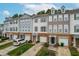 Charming townhomes featuring brick accents, varied siding, and attached garages, creating inviting curb appeal at 707 Sutter Gate Ln, Morrisville, NC 27560