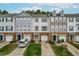 Charming townhomes featuring brick accents, varied siding, and attached garages, creating inviting curb appeal at 707 Sutter Gate Ln, Morrisville, NC 27560