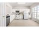 Bright kitchen features white cabinets, appliances, and ample counter space for meal preparation at 707 Sutter Gate Ln, Morrisville, NC 27560