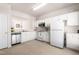 Bright kitchen features white cabinets, appliances, and ample counter space for meal preparation at 707 Sutter Gate Ln, Morrisville, NC 27560