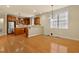 Open-concept kitchen and dining area with wood floors and stainless steel appliances at 7373 Newport Ave, Raleigh, NC 27613