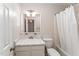 Neutral bathroom features a functional vanity, toilet, and shower with a shower curtain at 751 Benchmark Dr, Raleigh, NC 27615