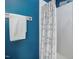 Close-up of a shower featuring modern tile, shower head, and a patterned shower curtain at 7634 Astoria Pl, Raleigh, NC 27612