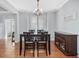 Bright dining room with hardwood floors, chandelier, and view to another room at 7634 Astoria Pl, Raleigh, NC 27612