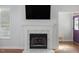 Close up of the fireplace with white mantel and a large television mounted above at 7634 Astoria Pl, Raleigh, NC 27612