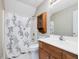 Cozy bathroom with shower featuring decorative curtain and wooden storage cabinet at 77 Double Oak Dr, Pittsboro, NC 27312