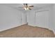 Bedroom featuring light-wood flooring, ceiling fan, closet and adjoining doorway at 7929 Falcon Rest Cir, Raleigh, NC 27615