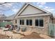 Exterior of home with a stone patio, seating, and a privacy fence at 812 Canyoncreek Ln, Fuquay Varina, NC 27526