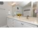 Bathroom featuring double sinks, white cabinets, a framed mirror, and decorative accents at 812 Canyoncreek Ln, Fuquay Varina, NC 27526