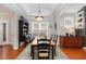 Elegant dining room with a tray ceiling, stylish light fixture, and a large window providing ample natural light at 812 Canyoncreek Ln, Fuquay Varina, NC 27526