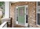 Charming green front door with sidelights and a decorative window at 812 Canyoncreek Ln, Fuquay Varina, NC 27526