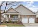 Charming single-story brick home features a cozy front porch and a two-car garage at 812 Canyoncreek Ln, Fuquay Varina, NC 27526