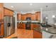 Modern kitchen featuring stainless steel appliances, granite countertops, custom cabinetry, and hardwood flooring at 812 Canyoncreek Ln, Fuquay Varina, NC 27526