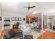 Open-concept living room with hardwood floors, modern furniture, and ample natural light at 812 Canyoncreek Ln, Fuquay Varina, NC 27526