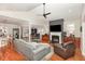 Spacious living room with hardwood floors, vaulted ceiling, and a cozy fireplace at 812 Canyoncreek Ln, Fuquay Varina, NC 27526