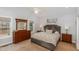 Comfortable main bedroom featuring neutral tones, a dresser with mirror, and a serene ambiance at 812 Canyoncreek Ln, Fuquay Varina, NC 27526
