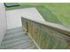 Wooden stairs leading to the backyard, with a concrete patio and fresh green grass at 83 Nottoway Lane, Wendell, NC 27591