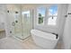 Bathroom showcasing soaking tub and seamless glass shower at 83 Nottoway Lane, Wendell, NC 27591