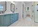 Bathroom with double vanity, black fixtures, marble floors, and frameless glass shower at 83 Nottoway Lane, Wendell, NC 27591