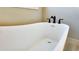 Close up of white soaking tub with black fixtures at 83 Nottoway Lane, Wendell, NC 27591