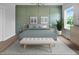 Cozy bedroom with decorative green paneled walls, hardwood floors, and a sun-filled window at 83 Nottoway Lane, Wendell, NC 27591