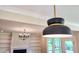 Elegant dining room featuring a modern chandelier, built-in shelves, and a fireplace at 83 Nottoway Lane, Wendell, NC 27591